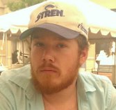 Picture of my face wearing a purple and white fishing hat